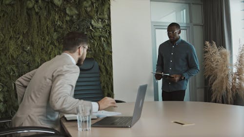 A Job Applicant Giving His Resume to the Interviewer