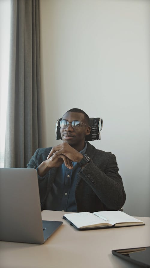 Young Man Sitting at Desk in Office