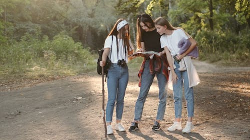 Teenage Girls Trekking in Forest Path
