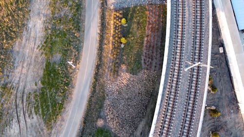 An Aerial Footage of Train Tracks beside a Road