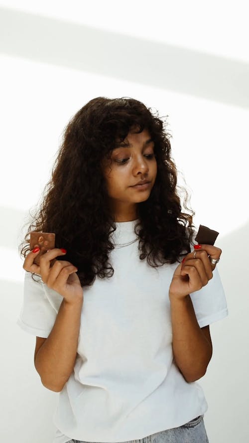 Young Woman Eating Chocolate Bar