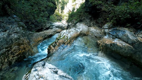 High Angle View of Stream Flowing Through Rocks