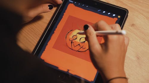 Person Drawing an Artwork on the Tablet