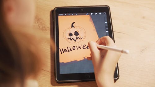 A Person Drawing on a Tablet