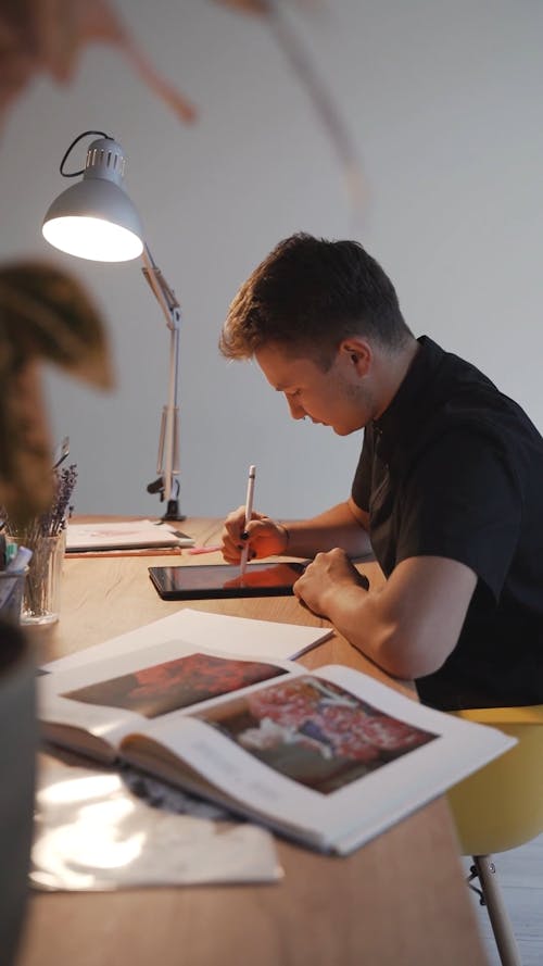 Young Man Drawing on a Tablet