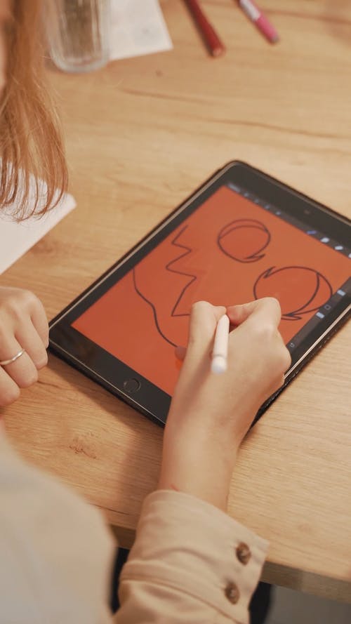 A Person Drawing on a Tablet