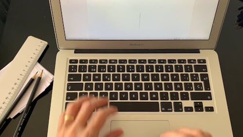 High Angle View of Hands Typing on Laptop 