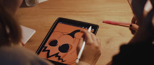 Person Drawing on a Tablet