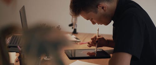 Young Man Drawing on a Tablet