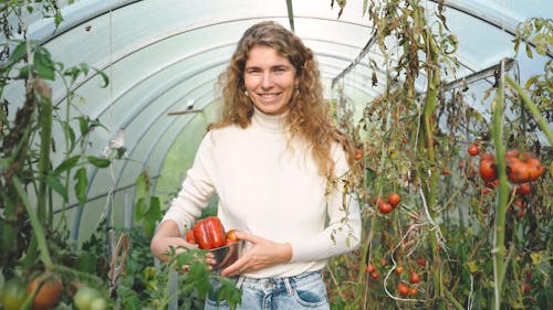 A Woman Walking in the Green House