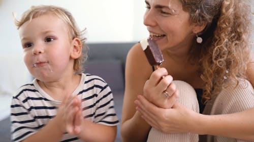 Happy Child and Mother Having Ice Cream