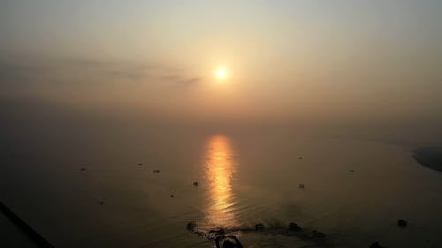 Scenery of a Foggy Lake During Golden Hour