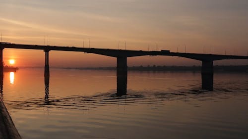 Silhouette of Vehicles Traveling on Bridge During Golden Hour