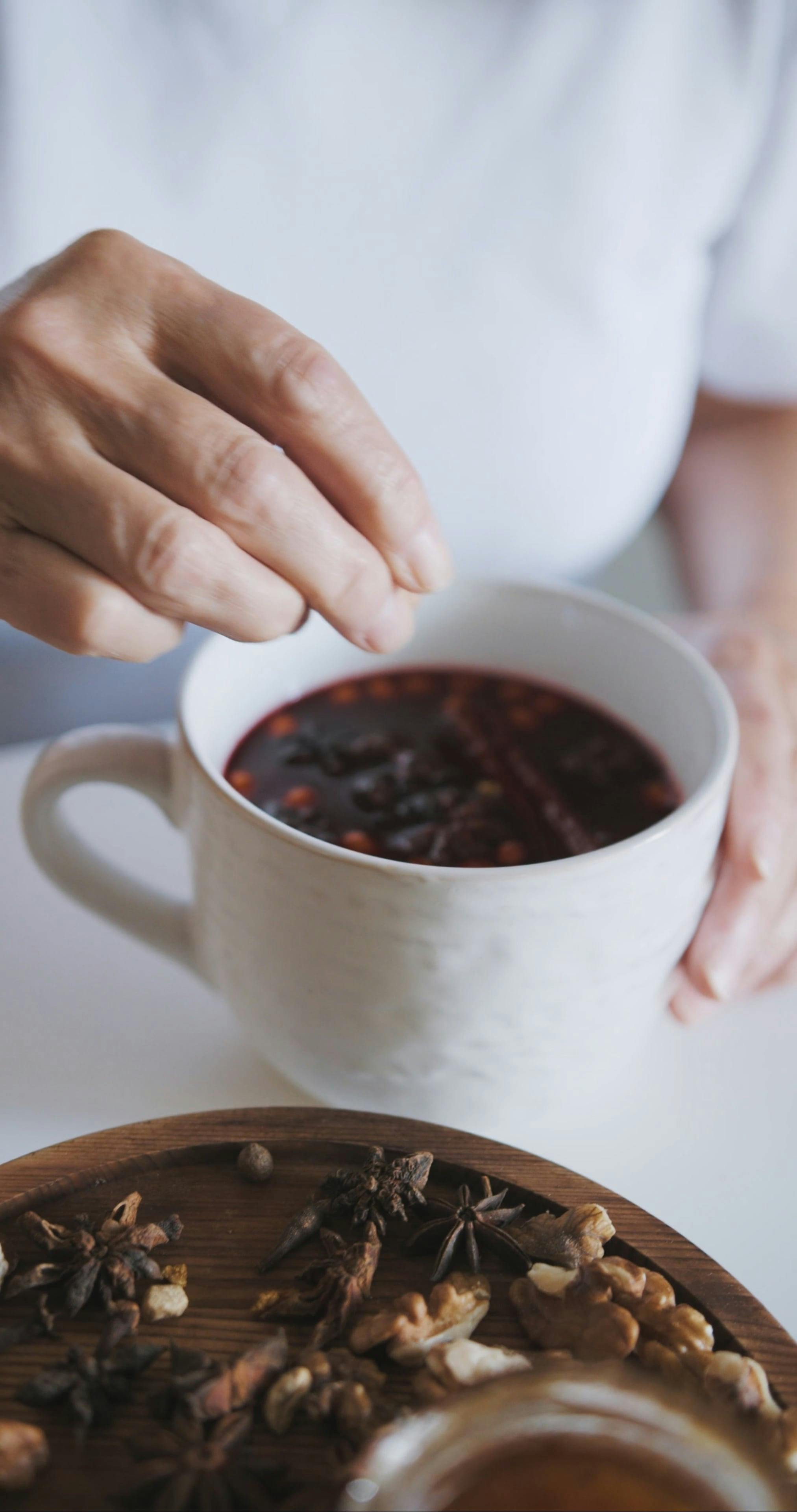 A Person Adding Spices on a Cup of Tea · Free Stock Video