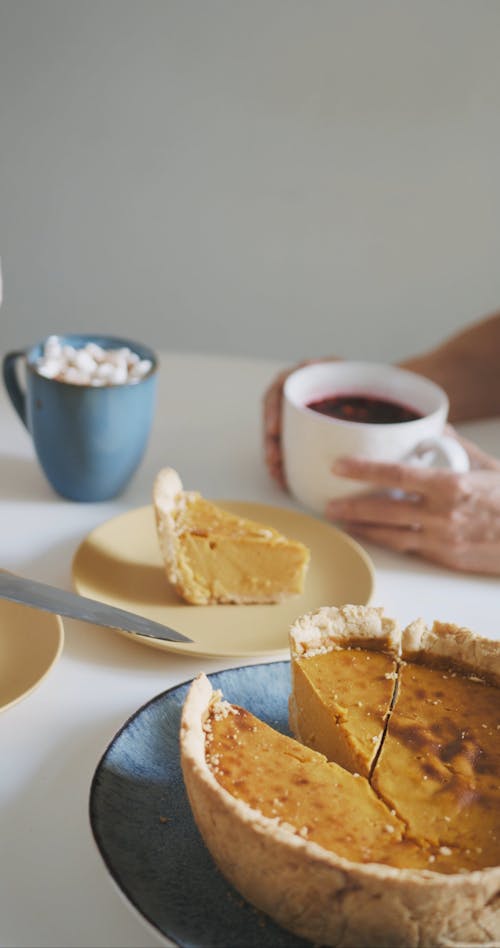 A Person Getting a Slice of Pumpkin Pie into the Plate