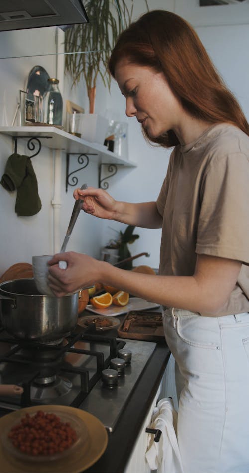 Young Woman Serving Hot Soup