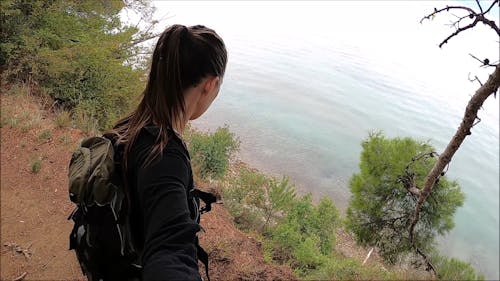 A Girls Standing By The Edge Of The Cliff