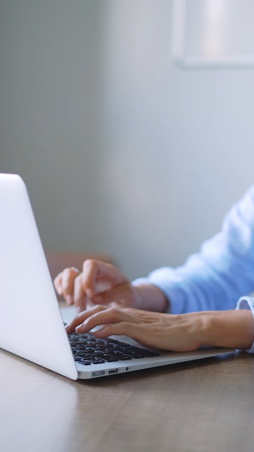 Person's Hands Using a Laptop for Typing