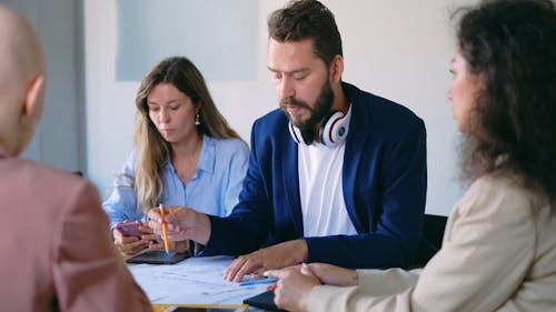 A Group Of People Attending A Business Meeting