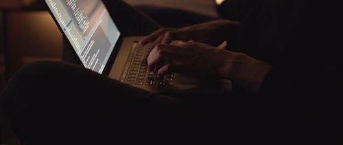 A Person Working Hard On A Computer Laptop