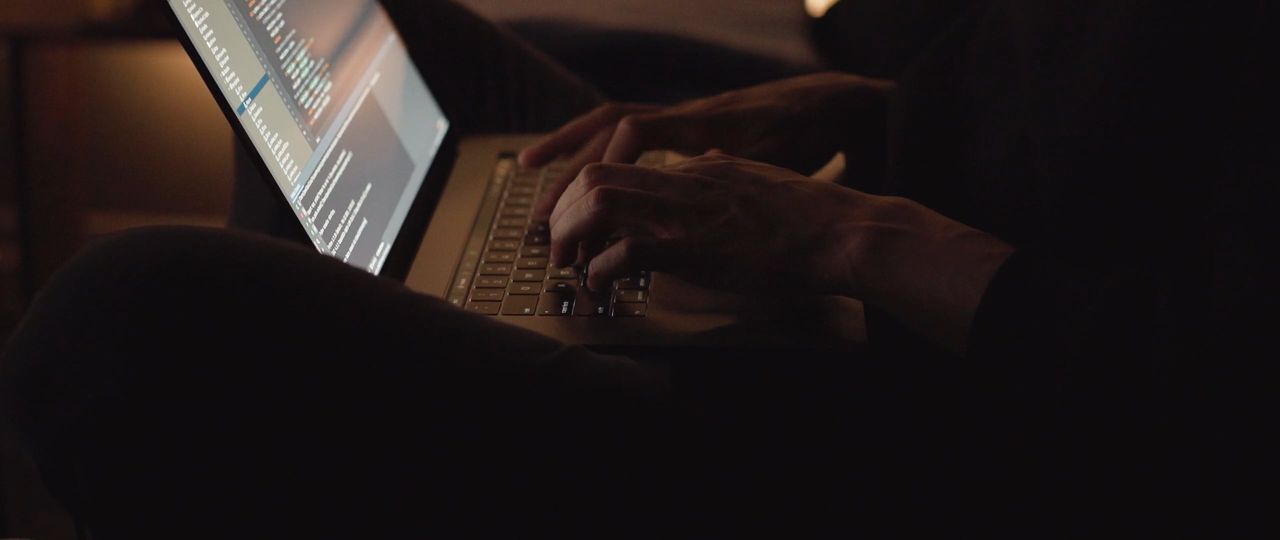 An engineer working through code and system output on a laptop