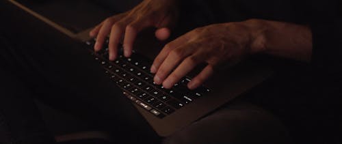 Person's Hands Using a Laptop for Typing