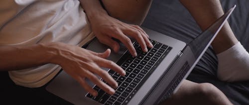 A Person Busy Working on His Laptop