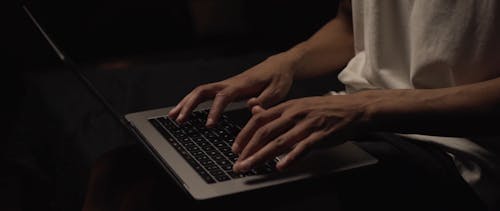 A Young Man Busy Working On His Laptop