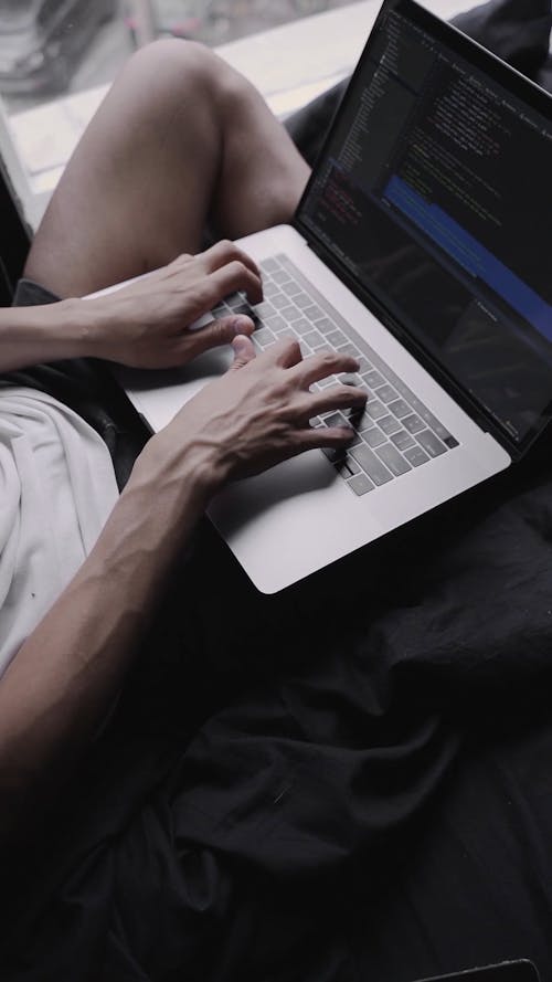 High Angle Shot of a Person Busy Working on His Laptop