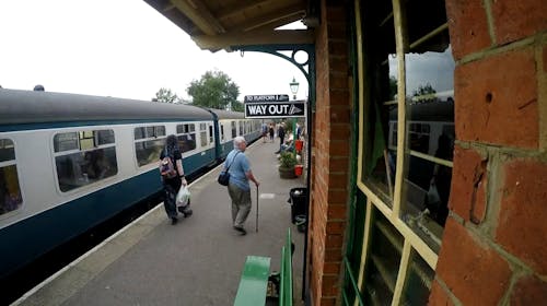 People Walking and Waiting on Train Platform