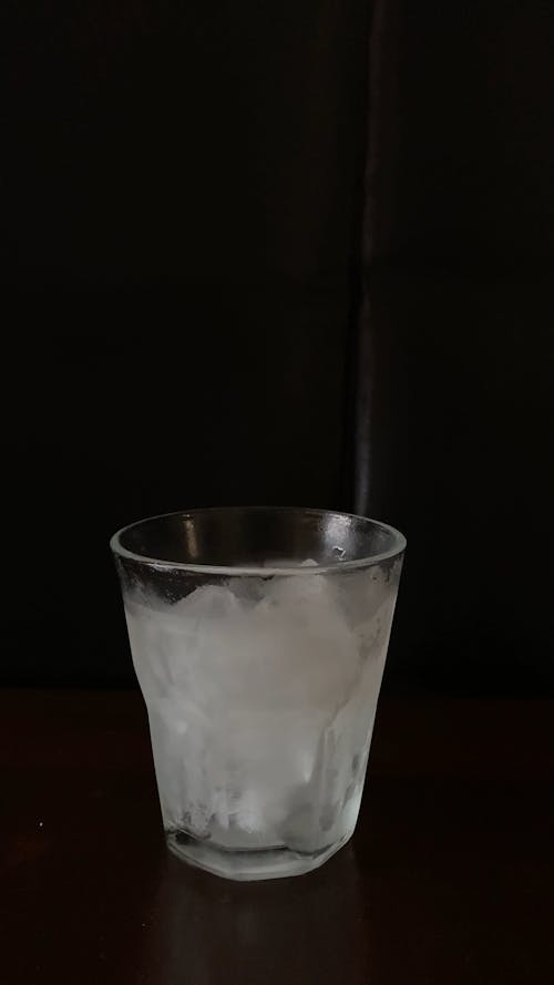 Adding Lemonade to a Glassed with Ice Cubes