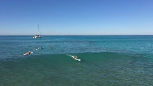 A Woman Surfing on Sea