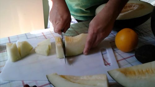 A Person Slicing a Fruit