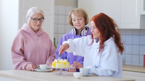 A Woman Cutting A Cake