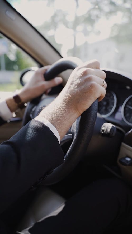 Hands Of A Man On The Steering Wheel