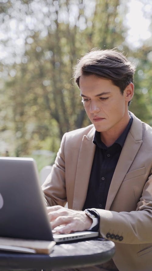 A Man Working On His Laptop Outdoors