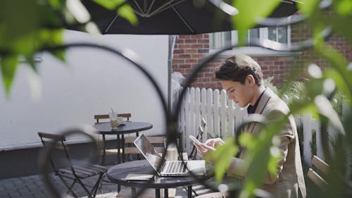 A Man Texting Using With His Cellphone