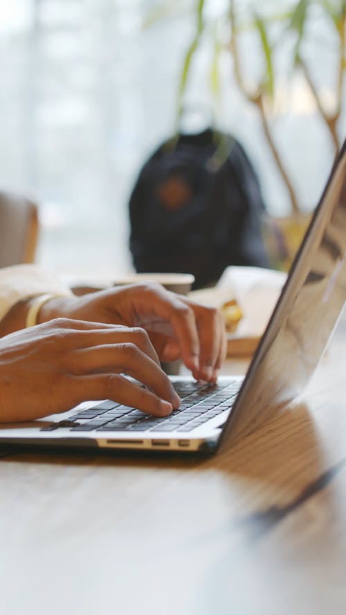 A Person Typing on the Laptop