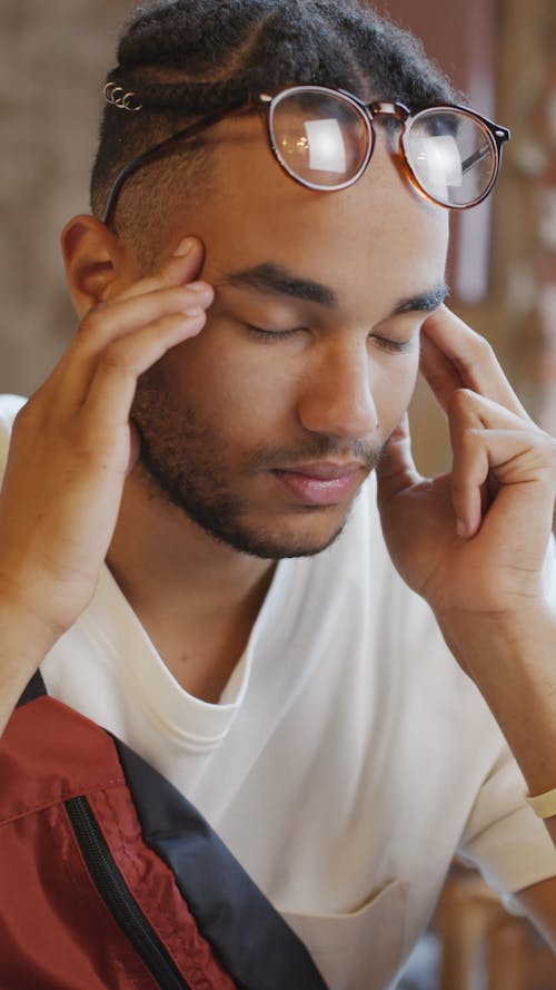 A Man Experiencing A Headache