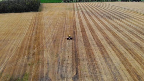 An Aerial Footage of a Tractor on a Field