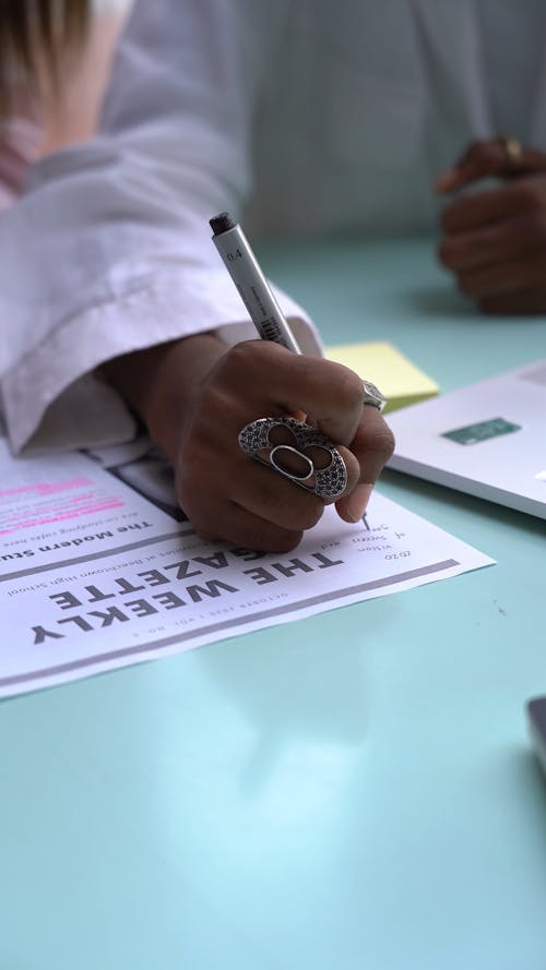 A Person Using a Pen for Writing