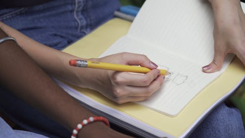 A Person Using a Pencil for Drawing