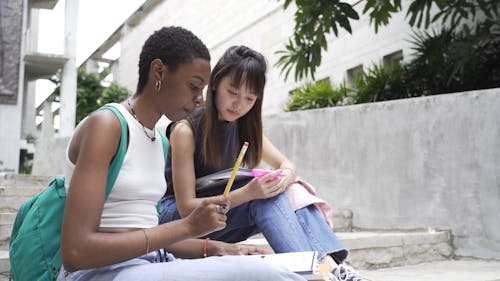 Women Reviewing Outdoor Their School Works