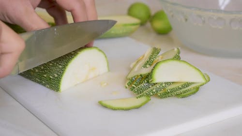 Close up of a Person Slicing a Cucumber