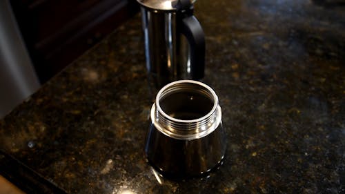 Close-Up View of a Person Adding Hot Water and Coffee