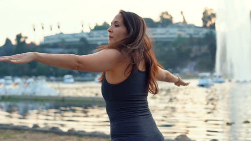 Happy Woman Doing Yoga at the Lake