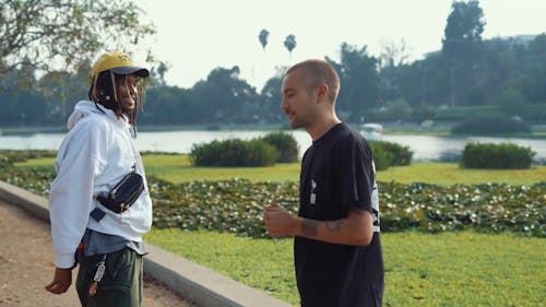 Men having a Conversation while Walking at a Park