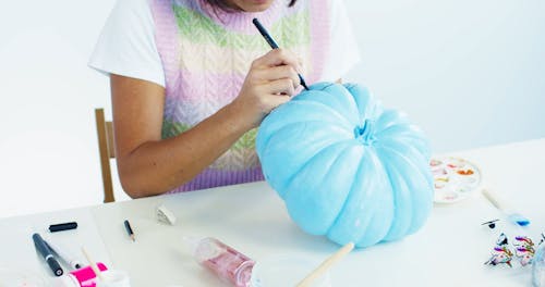 Woman Decorating Pumpkin
