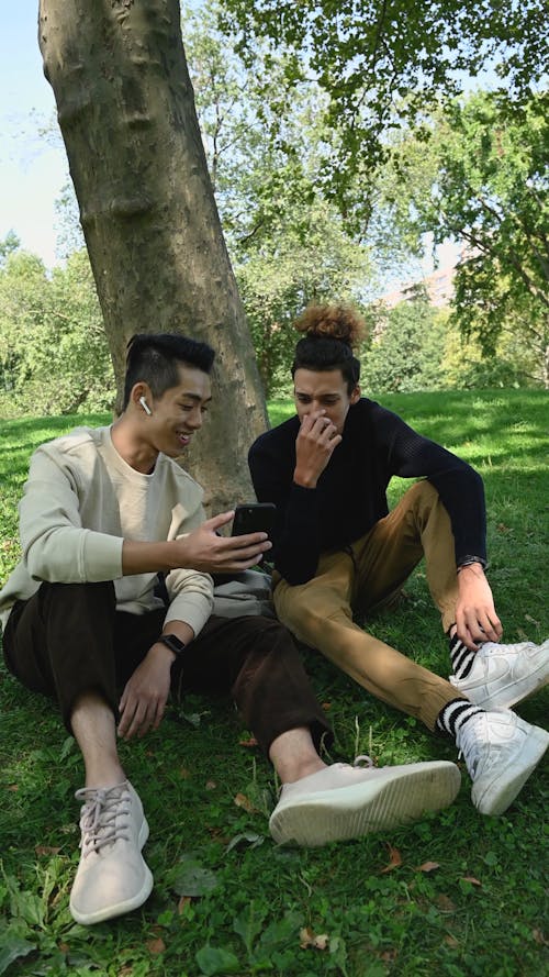 Smiling Young Men Using Smartphone 