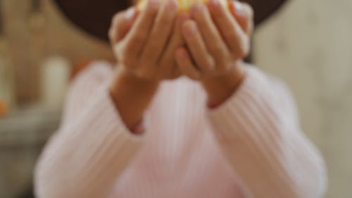 A Girl Holding A Small Pumpkin Gourd